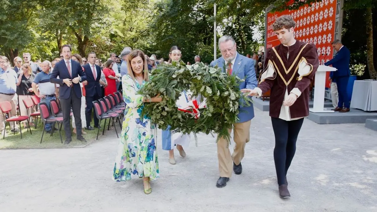 La presidenta de Cantabria, María José Sáenz de Buruaga, y el representante de las Casas de Cantabria, Serafín Fernández Vallejo, colocan la corona de laurel en el Día de las Instituciones