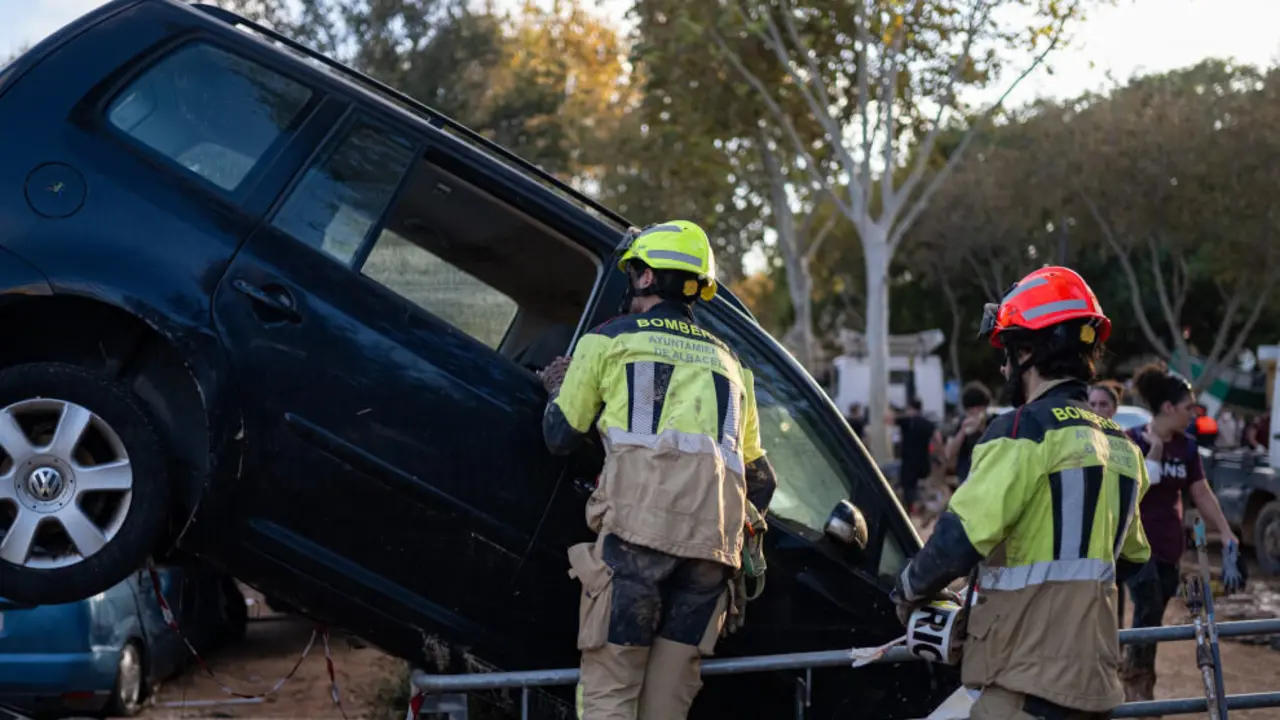 Dos bomberos trabajan en una zona afectada por la DANA